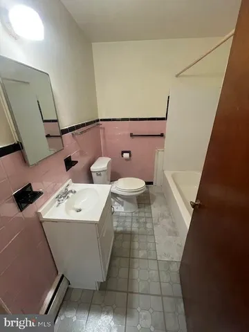 a bathroom with a sink toilet and mirror
