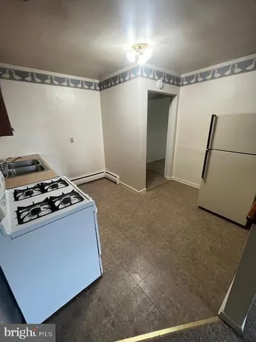 a kitchen with a stove and a refrigerator