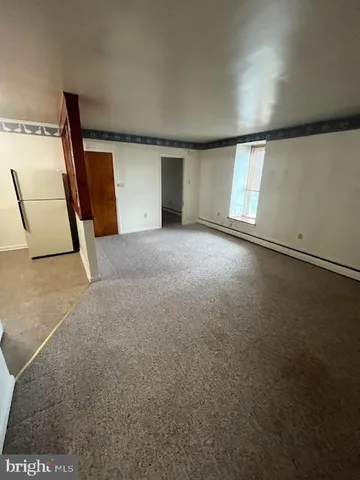 an empty room with a empty space and windows