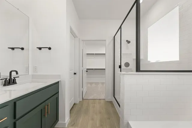 a bathroom with a glass shower door and a mirror