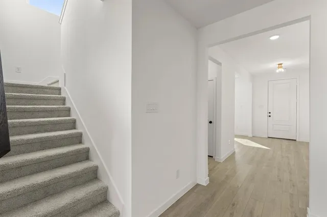 a room with kitchen island stainless steel appliances lots of counter space a sink and a window