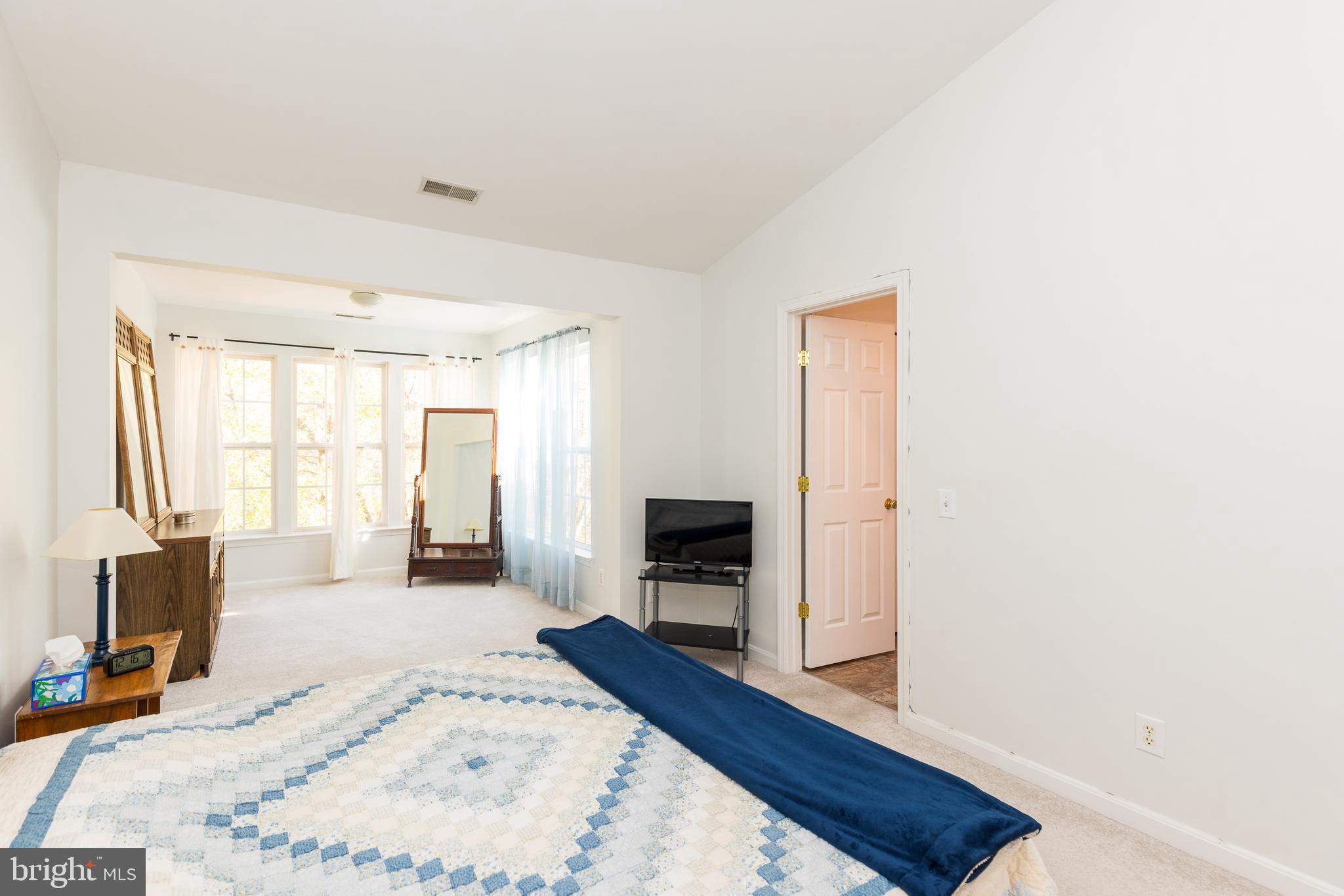 232 Night Haven Court Edgewater, MD 21037 - Photo 13 of 39 a large bedroom with wooden floor and a bed
