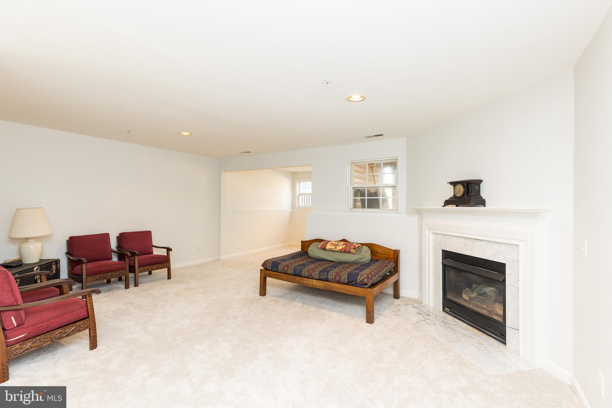 232 Night Haven Court Edgewater, MD 21037 - Photo 19 of 39 a living room with furniture a fireplace and a flat screen tv