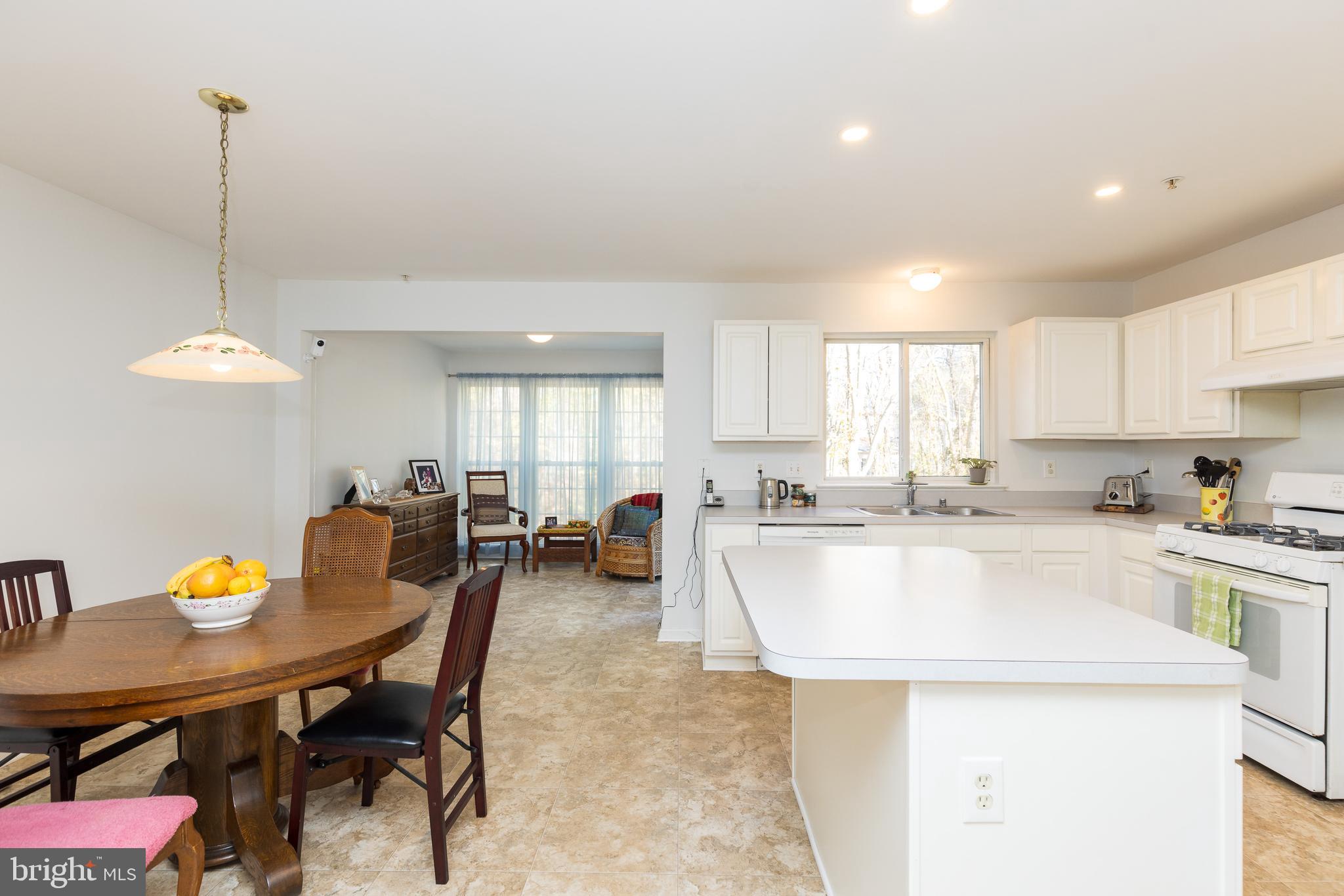 232 Night Haven Court Edgewater, MD 21037 - Photo 4 of 39 a large white kitchen with a table and chairs