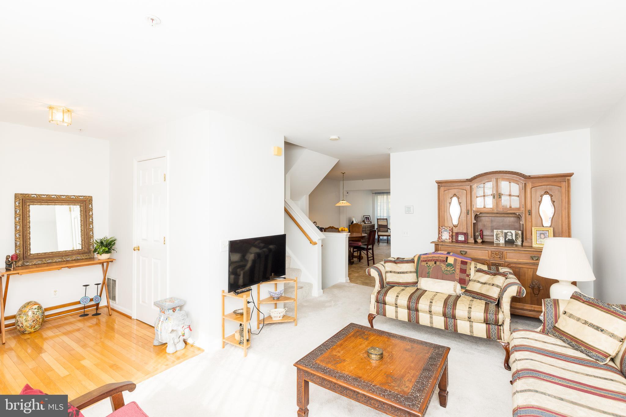 232 Night Haven Court Edgewater, MD 21037 - Photo 6 of 39 a living room with furniture a flat screen tv and a table