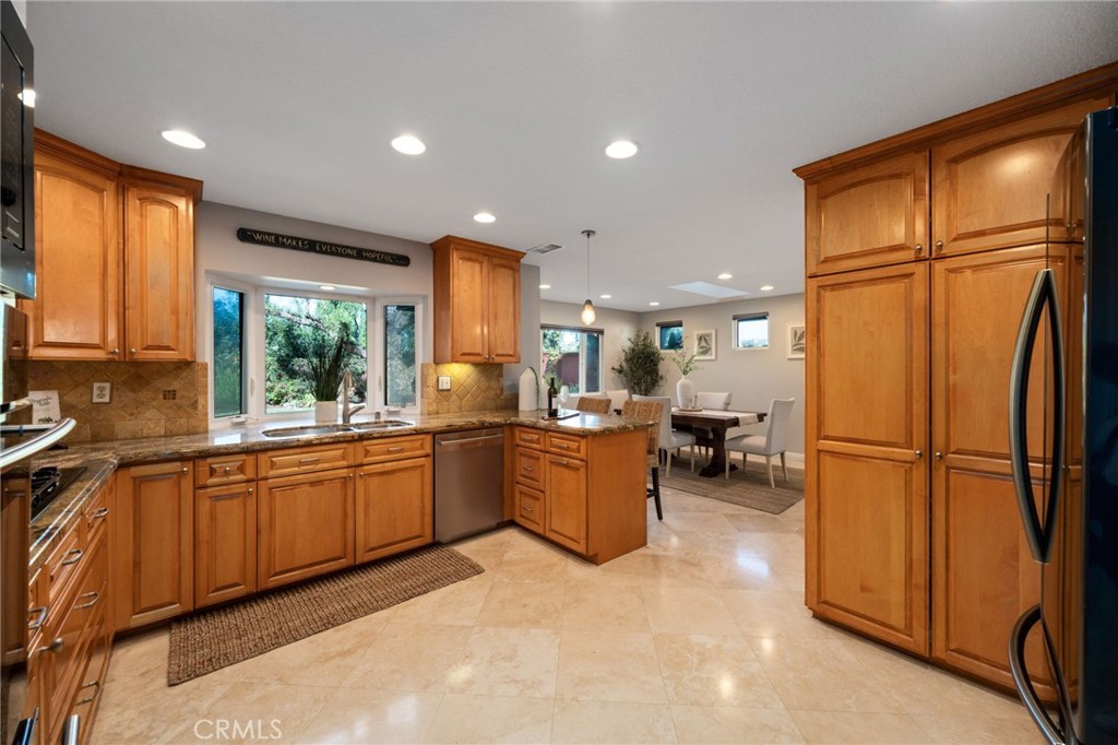 25695 La Cima Laguna Niguel, CA 92677 - Photo 12 of 52 a kitchen with sink refrigerator and cabinets