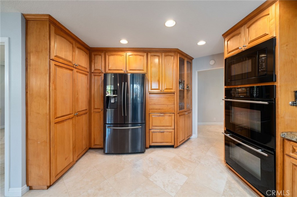 25695 La Cima Laguna Niguel, CA 92677 - Photo 14 of 52 a kitchen with stainless steel appliances a refrigerator and microwave