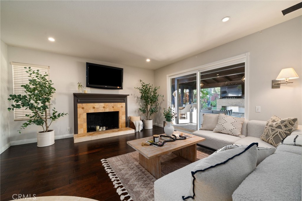 25695 La Cima Laguna Niguel, CA 92677 - Photo 15 of 52 a living room with furniture a flat screen tv and a fireplace