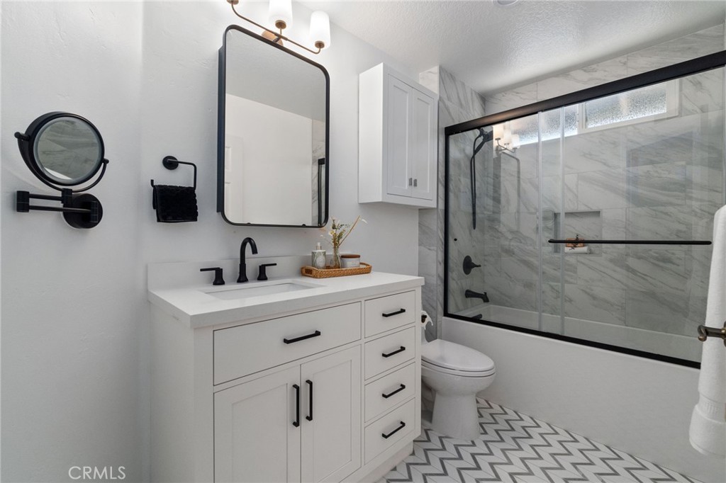 25695 La Cima Laguna Niguel, CA 92677 - Photo 17 of 52 a bathroom with a toilet sink double vanity and mirror