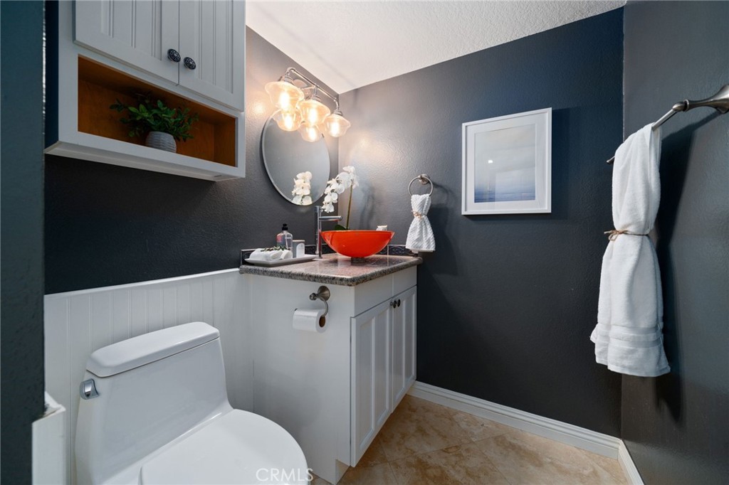 25695 La Cima Laguna Niguel, CA 92677 - Photo 33 of 52 a bathroom with a toilet sink vanity and mirror