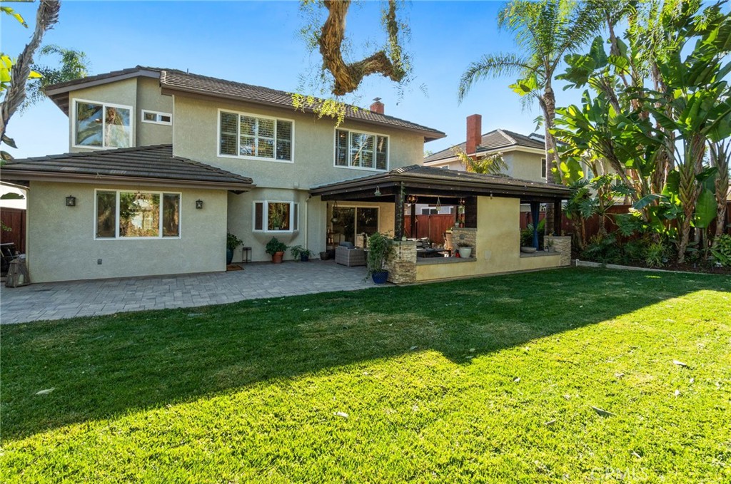 25695 La Cima Laguna Niguel, CA 92677 - Photo 37 of 52 a front view of a house with a garden and trees