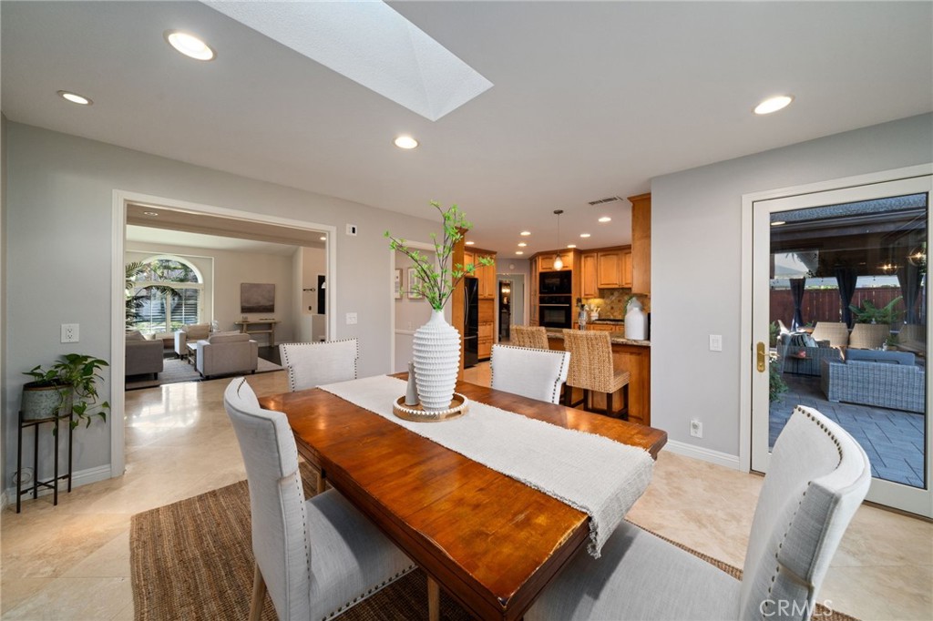 25695 La Cima Laguna Niguel, CA 92677 - Photo 8 of 52 a living room with furniture a dining table and chairs in it