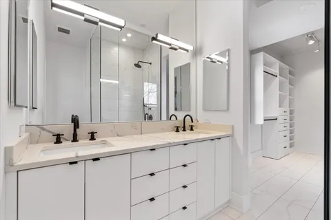 a bedroom with a bed mirror and window