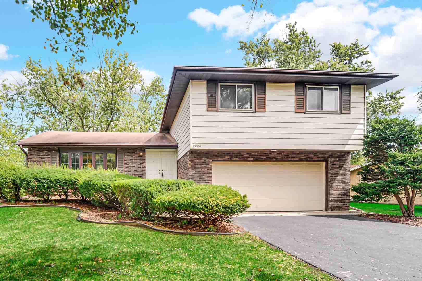 2826 Walnut Road Homewood, IL 60430 - Photo 1 of 20 a front view of a house with a yard and potted plants