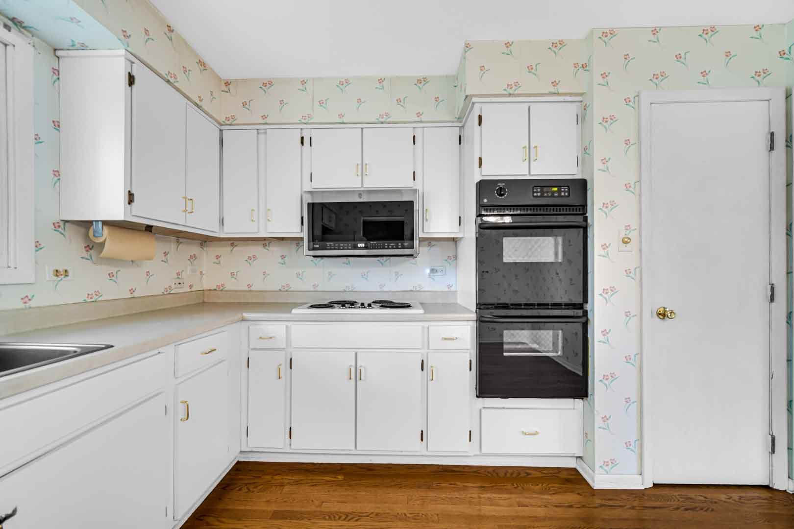 2826 Walnut Road Homewood, IL 60430 - Photo 3 of 20 a kitchen with stainless steel appliances a white cabinet and a stove top oven