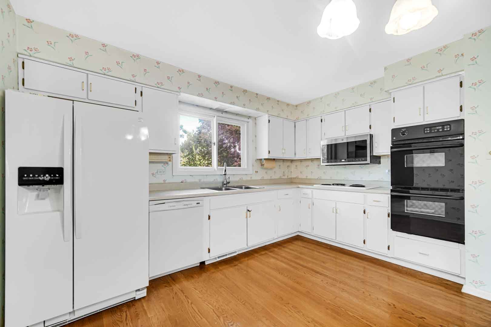 2826 Walnut Road Homewood, IL 60430 - Photo 4 of 20 a kitchen with white cabinets and appliances