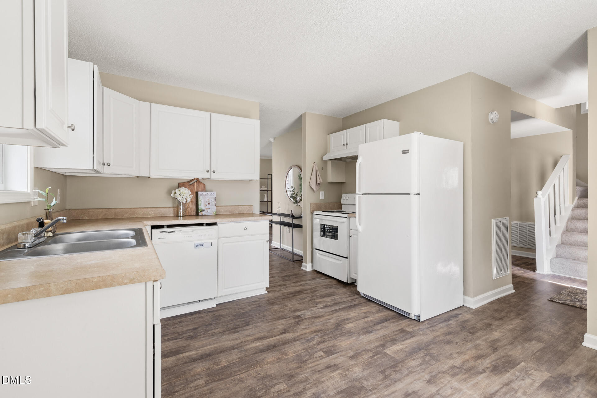 1004 Cheviot Avenue Durham, NC 27707 - Photo 11 of 34 a kitchen with white cabinets and white appliances