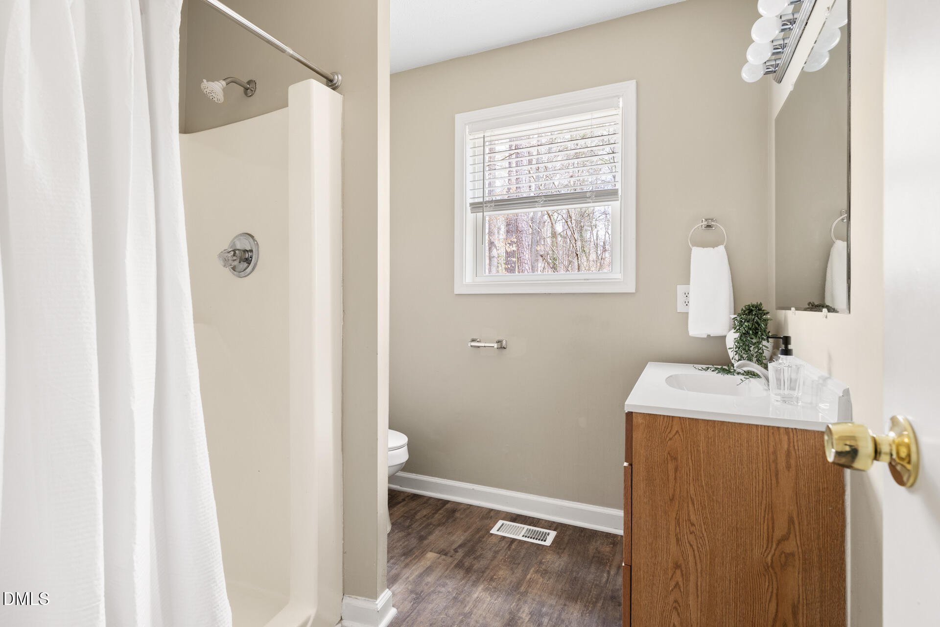 1004 Cheviot Avenue Durham, NC 27707 - Photo 22 of 34 a bathroom with a sink a mirror and shower