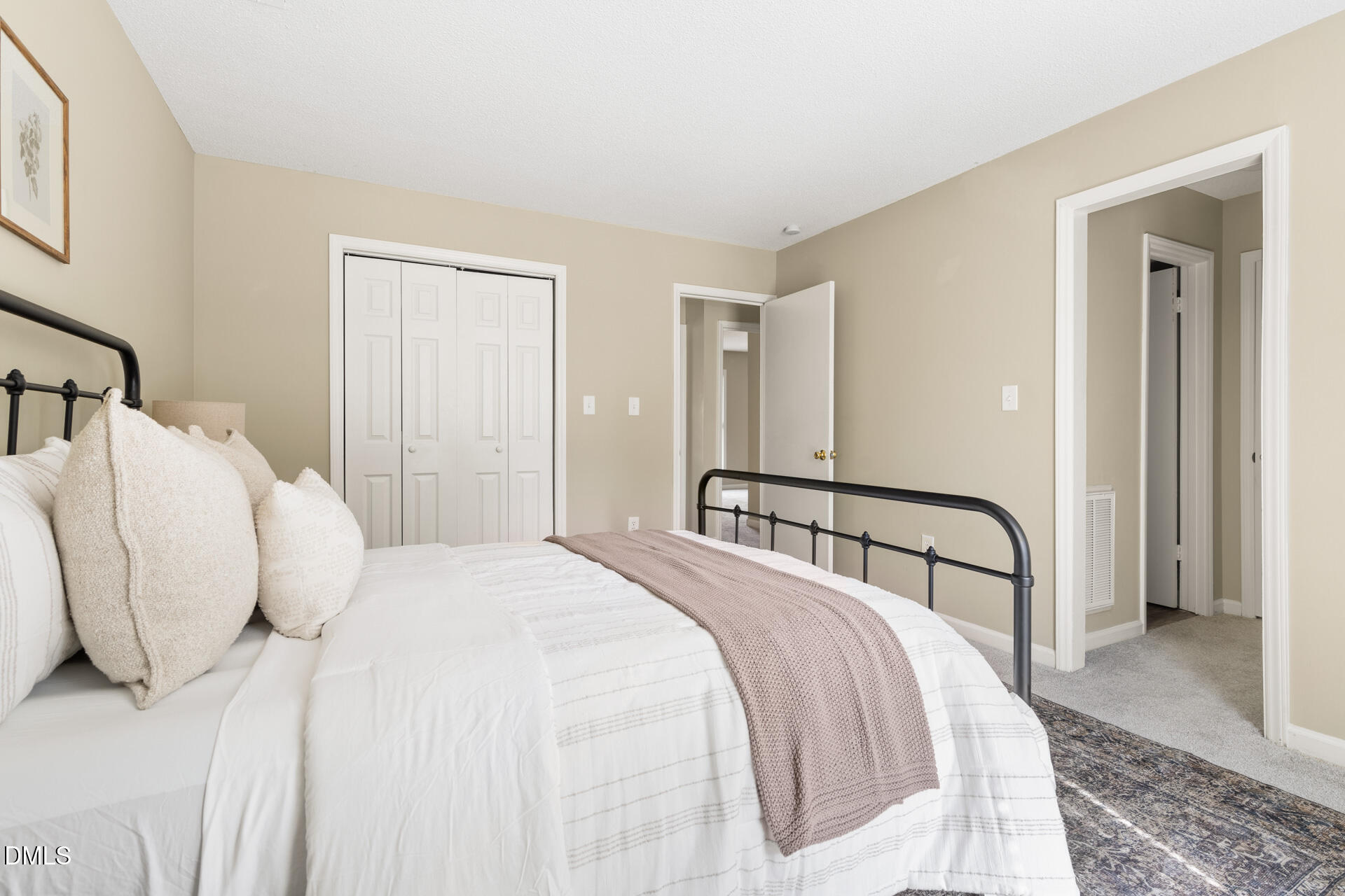 1004 Cheviot Avenue Durham, NC 27707 - Photo 25 of 34 a bedroom with a bed and a large mirror