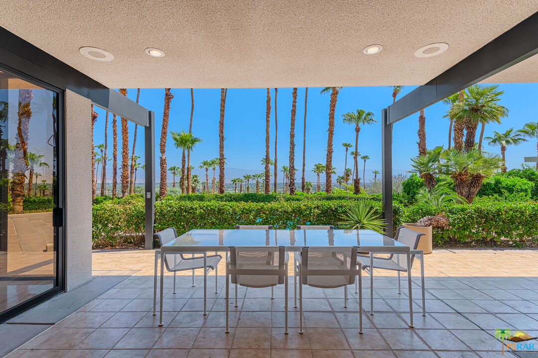 70170 Sonora Road Rancho Mirage, CA 92270 - Photo 23 of 45 a view of a patio with a table and chairs and potted plants