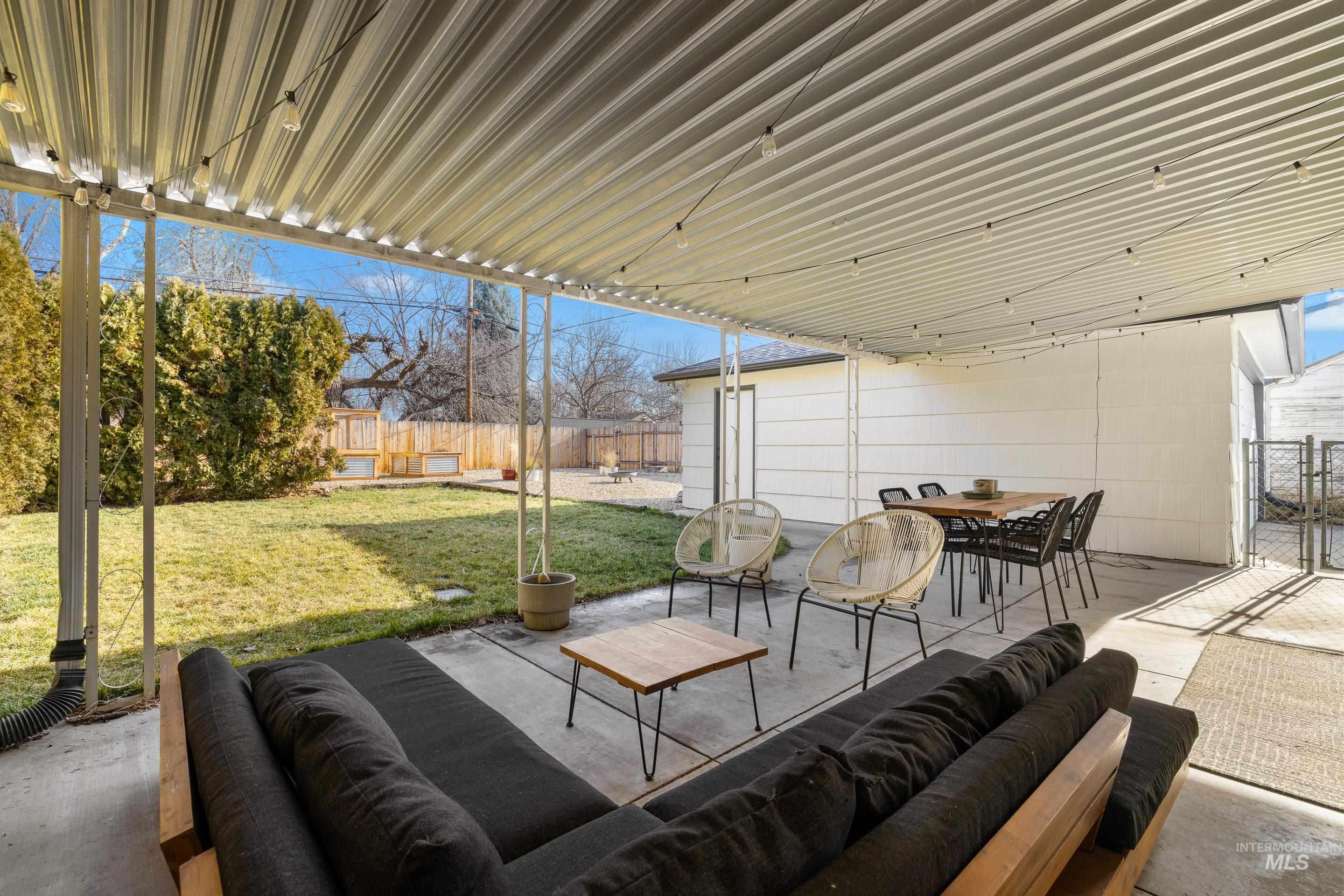 1010 Forrest Street Boise, ID 83705 - Photo 38 of 50 Fenced backyard with a patio, an outdoor hangout area, and outdoor dining area