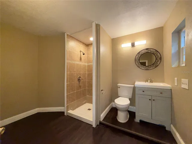 a bathroom with a toilet sink and a mirror
