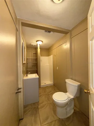 a bathroom with a toilet a sink and a shower