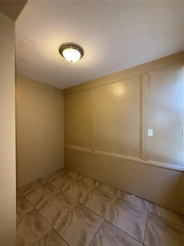 an empty room with a empty space and window