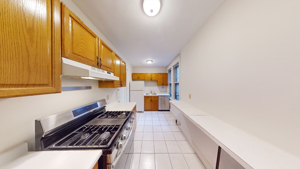 32 Sidlaw Road, Unit 7 Boston, MA 02135 - Photo 2 of 10 a kitchen with a sink and a stove top oven
