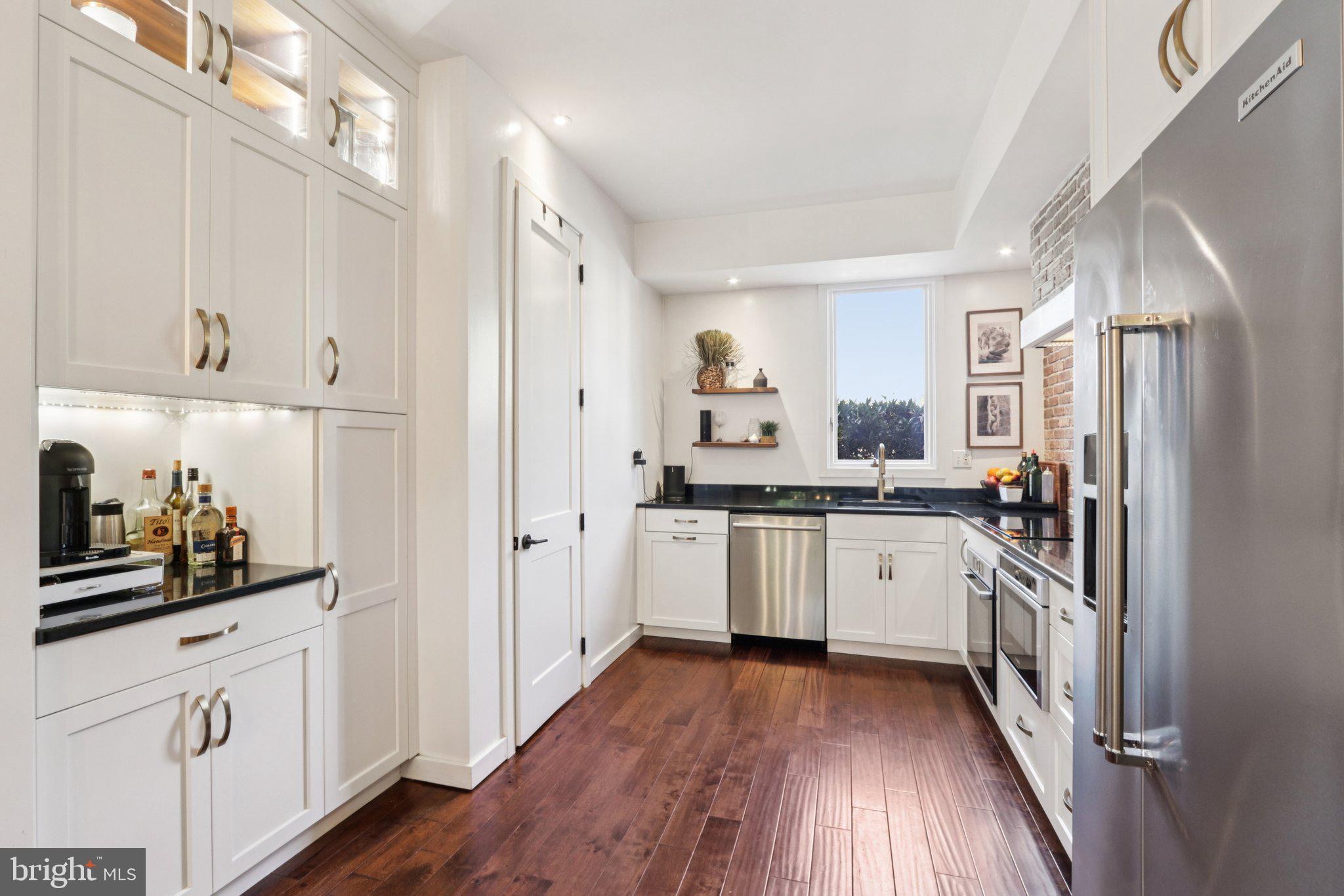 6 Avignon Devon, PA 19333 - Photo 19 of 61 a kitchen with white cabinets and stainless steel appliances