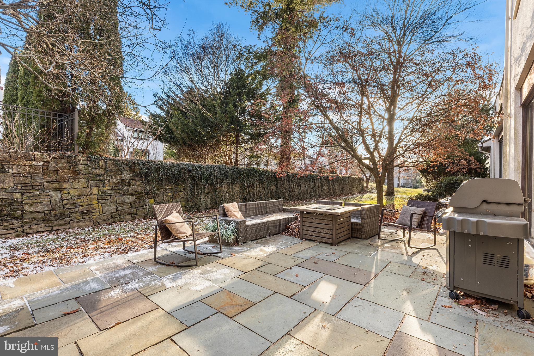 6 Avignon Devon, PA 19333 - Photo 20 of 57 a view of a patio with chairs and a fire pit