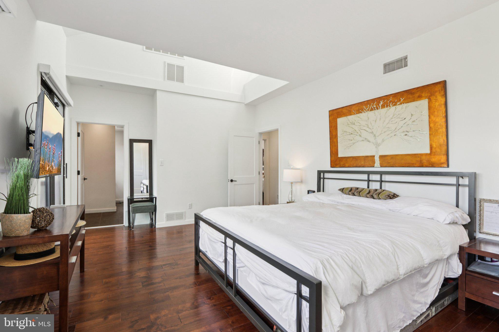6 Avignon Devon, PA 19333 - Photo 25 of 61 a bedroom with a bed and dresser with wooden floor