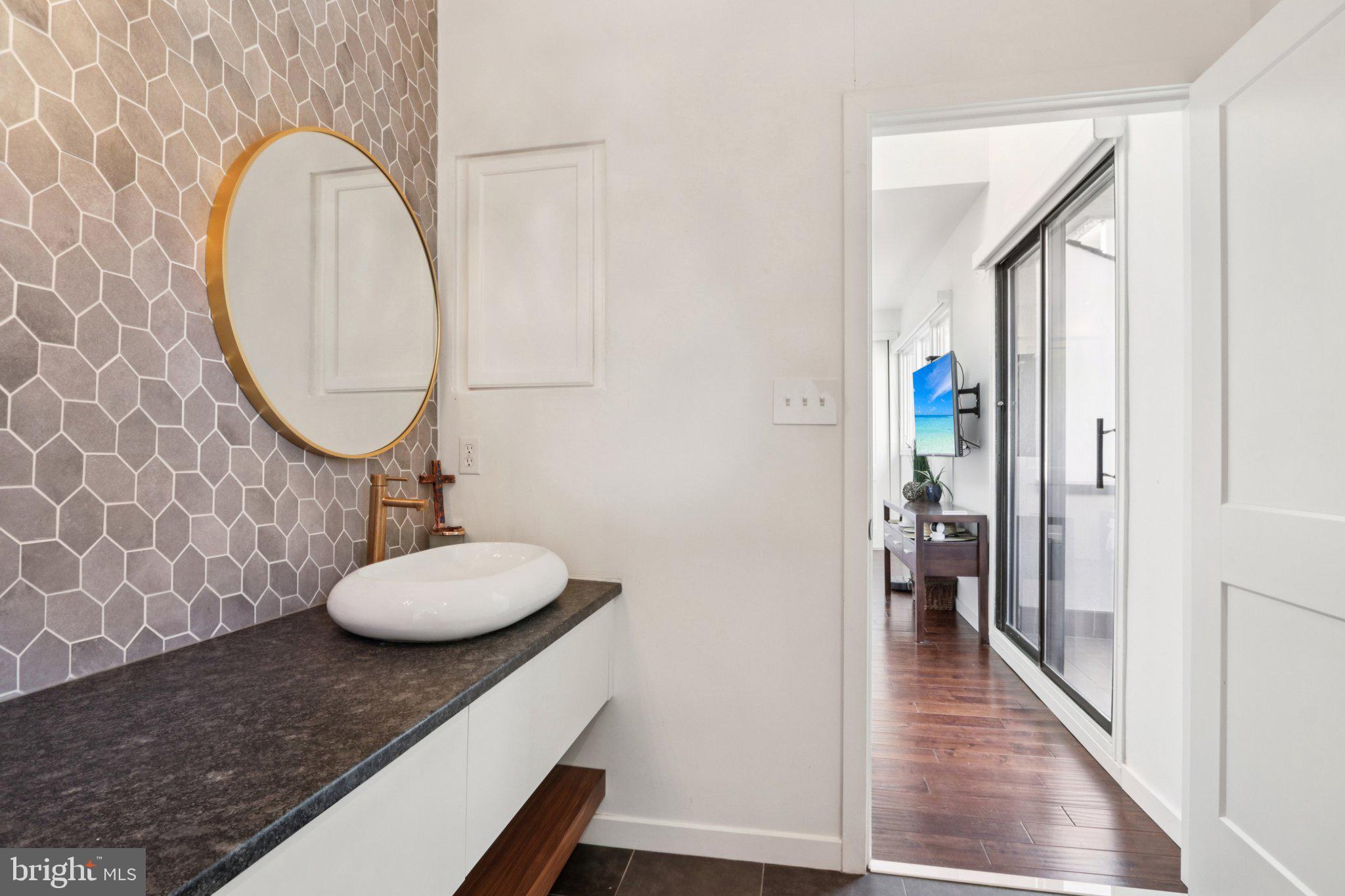 6 Avignon Devon, PA 19333 - Photo 30 of 61 a bathroom with a granite countertop sink and a mirror