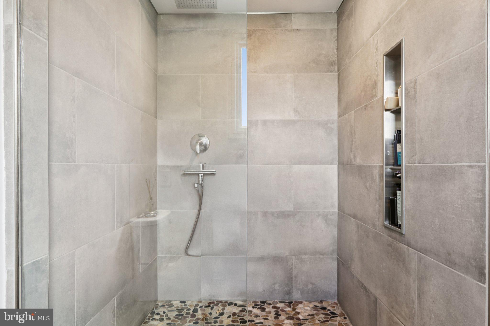 6 Avignon Devon, PA 19333 - Photo 33 of 57 a bathroom with a glass shower door