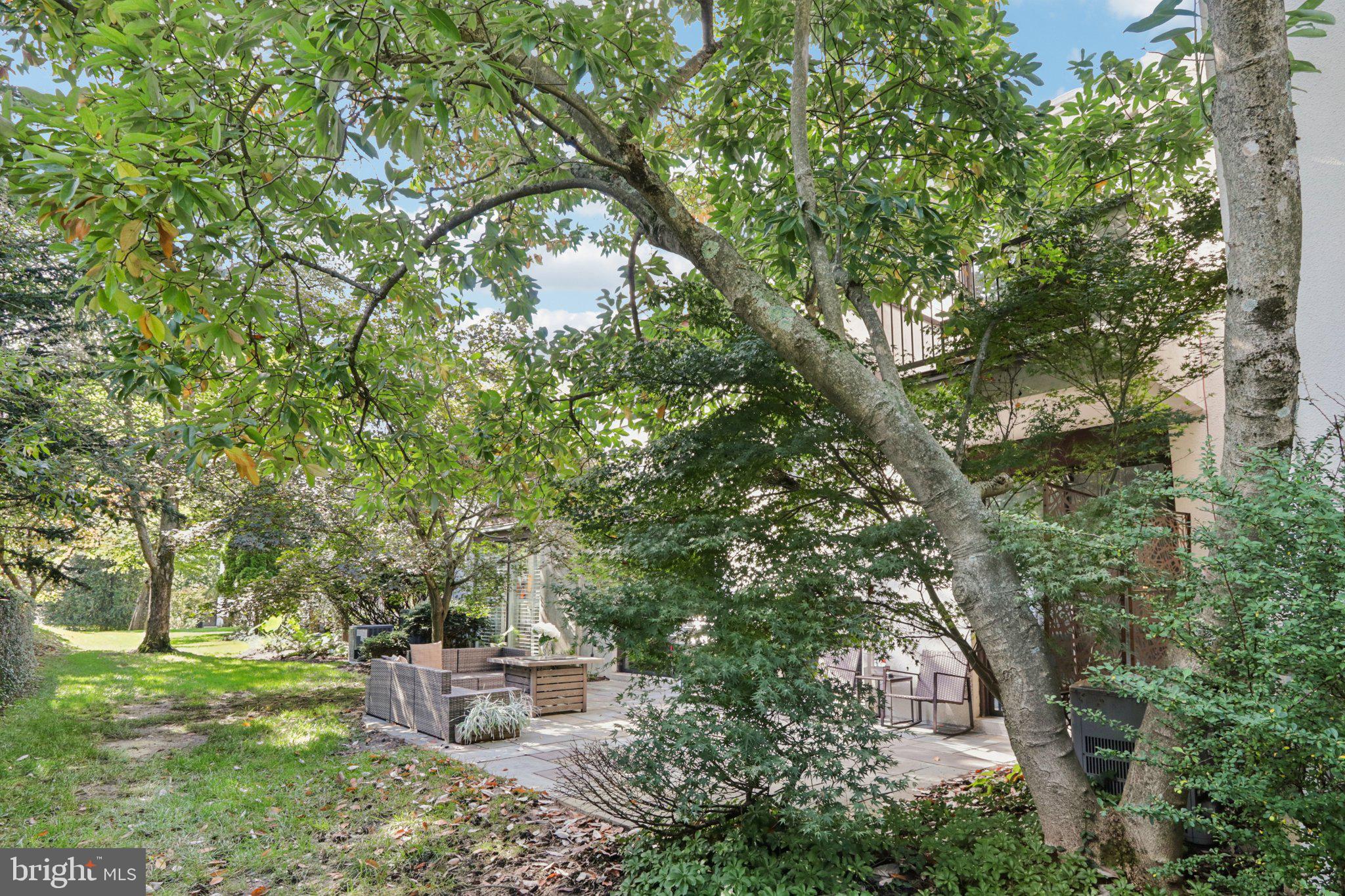 6 Avignon Devon, PA 19333 - Photo 55 of 61 a backyard of a house with outdoor seating and trees