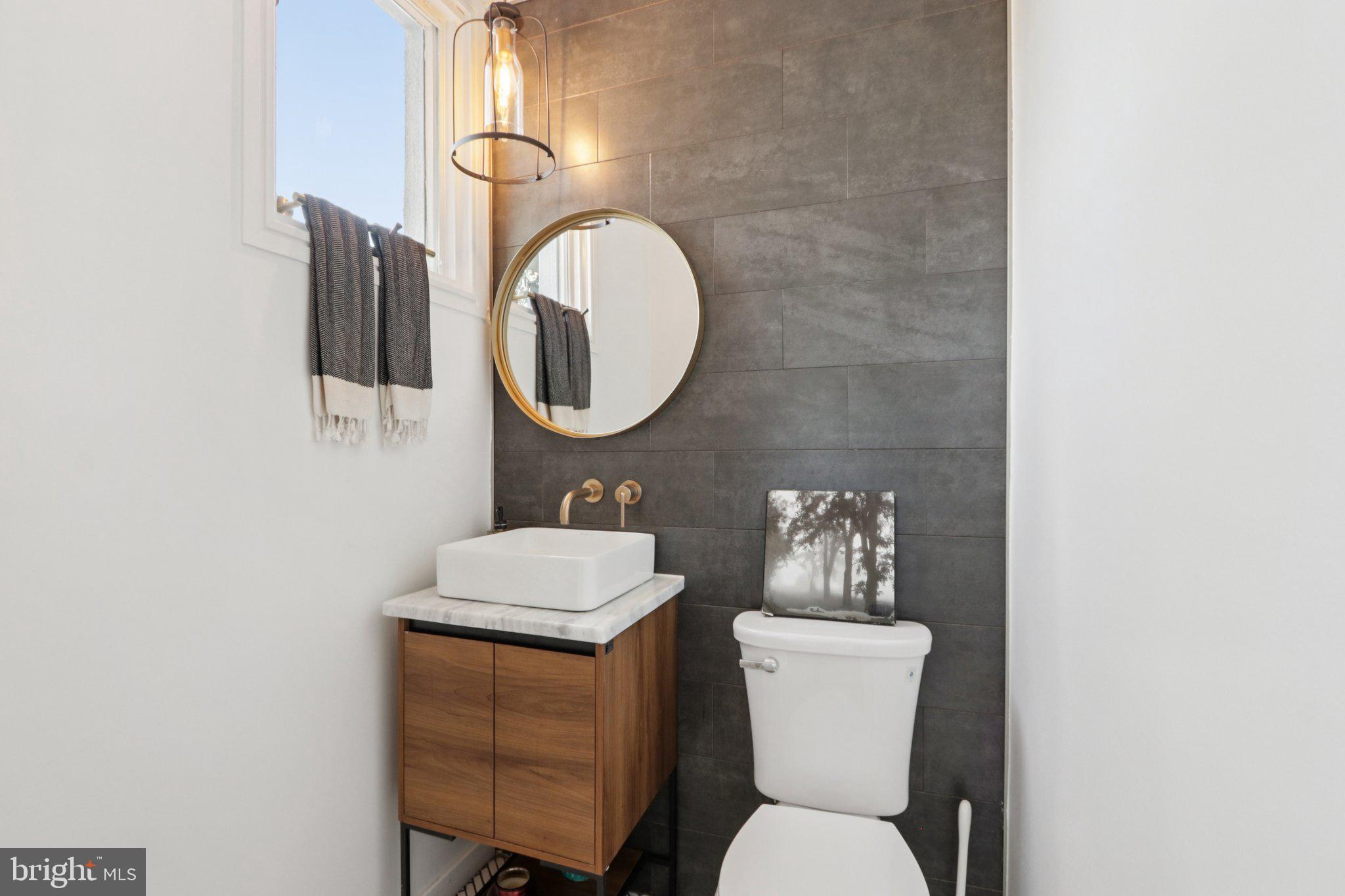 6 Avignon Devon, PA 19333 - Photo 6 of 57 a bathroom with a toilet a sink and mirror