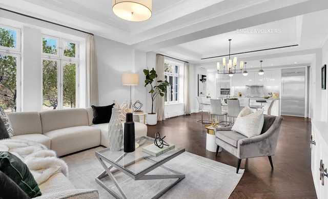 a living room with furniture and a chandelier