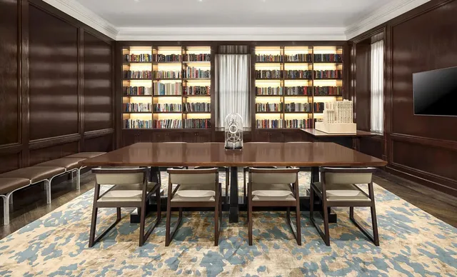 a living room with furniture and a book shelf