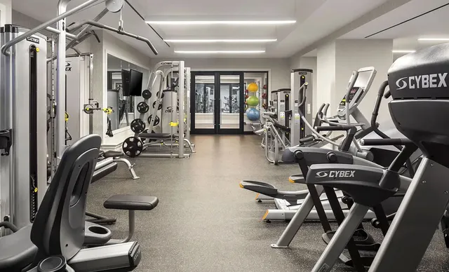 a dining room with wooden floor and furniture