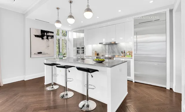 a hallway with sink mirror and cabinets
