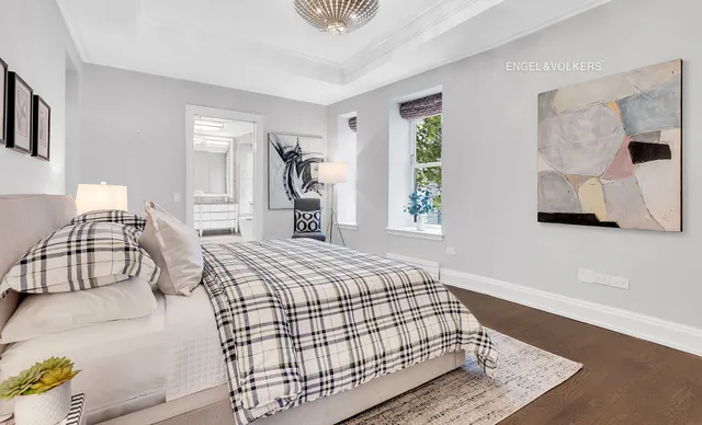 a view of a dining room and livingroom with furniture wooden floor a chandelier