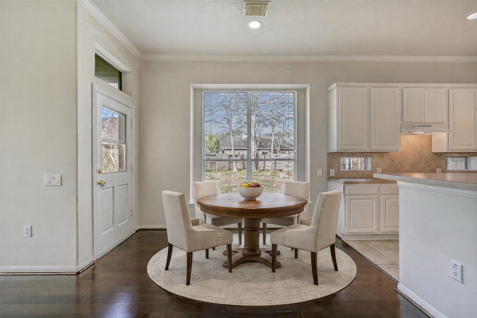 1448 North Riviera Circle Pearland, TX 77581 - Photo 10 of 35 Breakfast nook with backyard views offers a comfortable space for casual dining. Conveniently located between the kitchen and living area with easy access to the back patio. Note: this photo has been virtually staged.