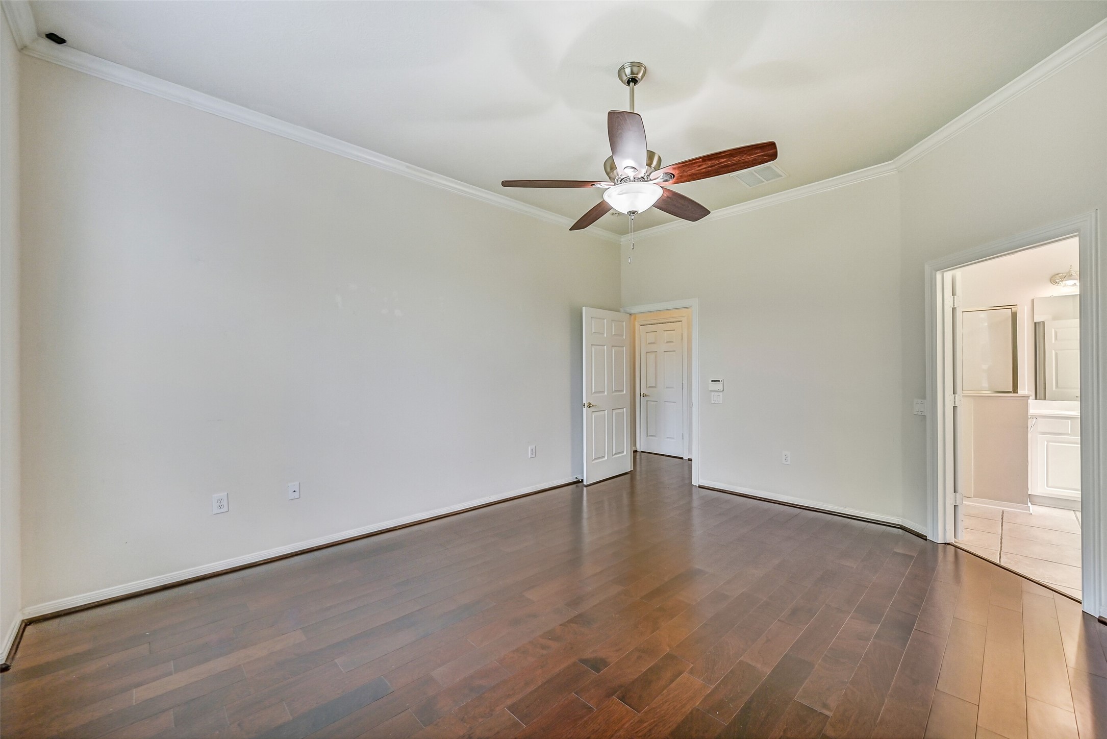1448 North Riviera Circle Pearland, TX 77581 - Photo 15 of 35 Another view of the primary suite showing convenient access to the en suite bath and the home’s living areas.