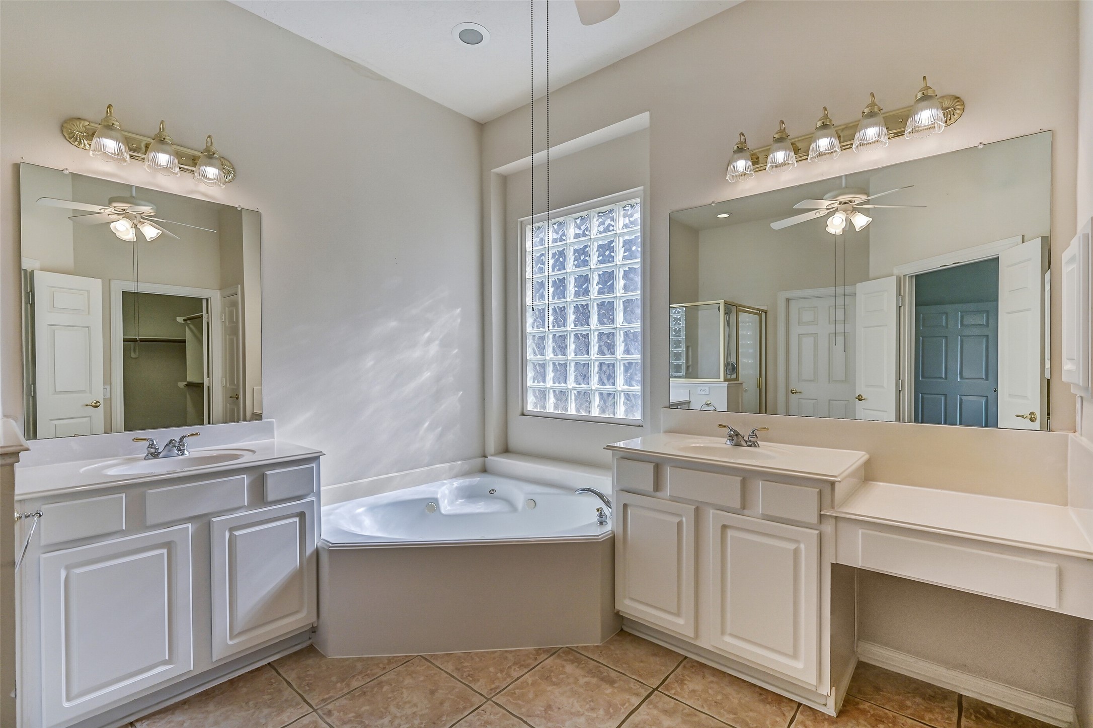 1448 North Riviera Circle Pearland, TX 77581 - Photo 16 of 35 Primary bath features dual vanities, a jetted soaking tub, and a separate shower with built-in bench seat.