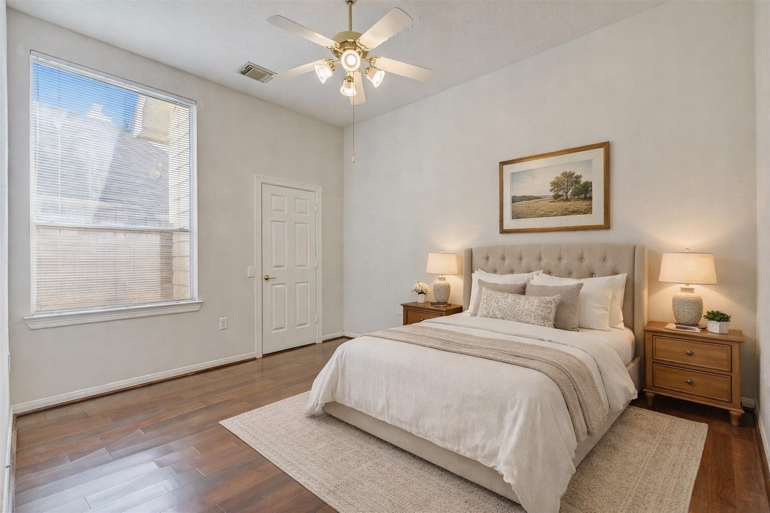 1448 North Riviera Circle Pearland, TX 77581 - Photo 20 of 35 Additional guest bedroom (one of two guest beds) with ceiling fan and closet storage. Closet flooring currently carpeted; seller notes additional flooring is stored in the attic. Note: this photo has been virtually staged.