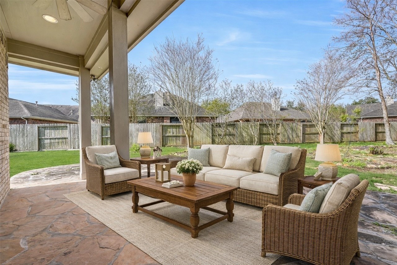 1448 North Riviera Circle Pearland, TX 77581 - Photo 22 of 35 Covered back patio with ceiling fan offers a comfortable outdoor space for relaxing or entertaining. Note: this photo has been virtually staged.