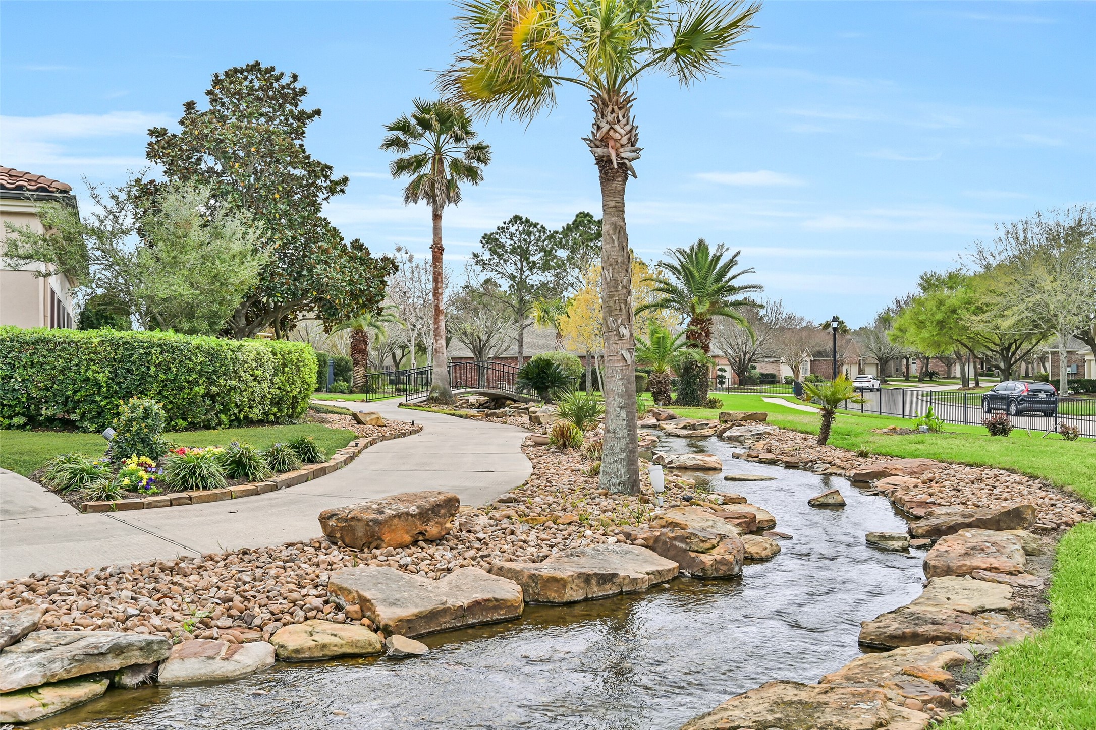 1448 North Riviera Circle Pearland, TX 77581 - Photo 28 of 35 Scenic walking trail winds throughout the community alongside a peaceful stream, offering a beautiful setting for daily walks and outdoor enjoyment. One of the many features that make Bellavita’s 55+ lifestyle so special.