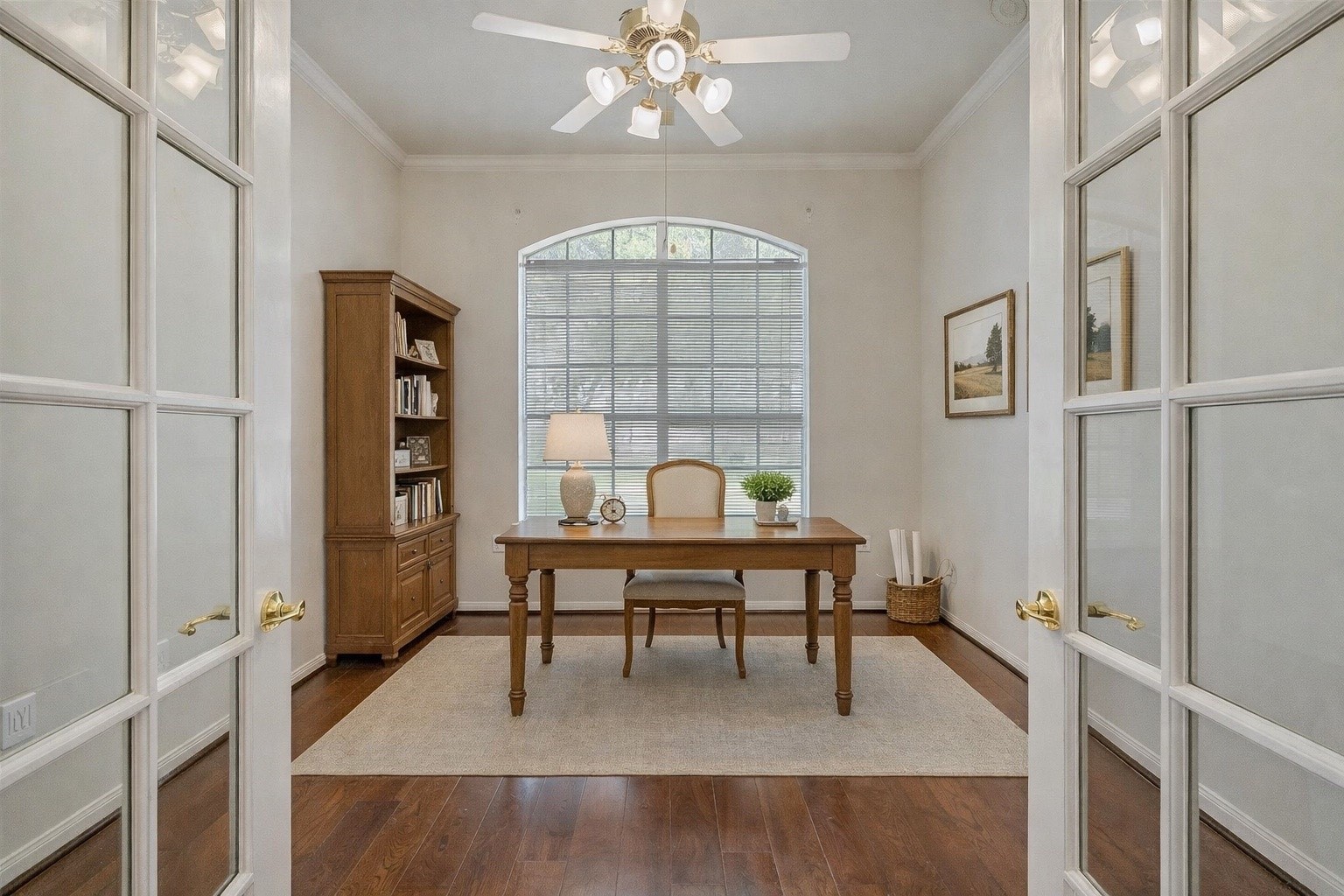 1448 North Riviera Circle Pearland, TX 77581 - Photo 7 of 35 Versatile front room with French doors offers endless possibilities — ideal as a study, formal living room, or hobby space. A large window overlooks the front yard while crown molding and a ceiling fan add comfort and character. Note: this photo has been virtually staged.