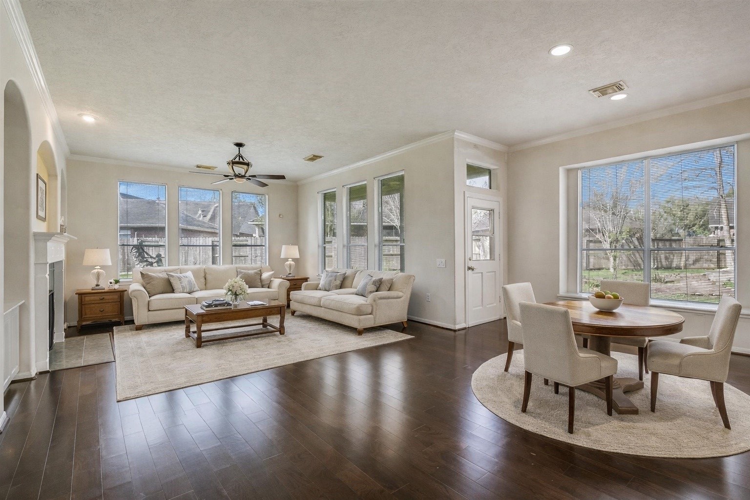 1448 North Riviera Circle Pearland, TX 77581 - Photo 8 of 35 Light and bright family room featuring engineered hardwood floors and large windows overlooking the expansive backyard. The open layout connects seamlessly to the kitchen and breakfast area. Note: this photo has been virtually staged.