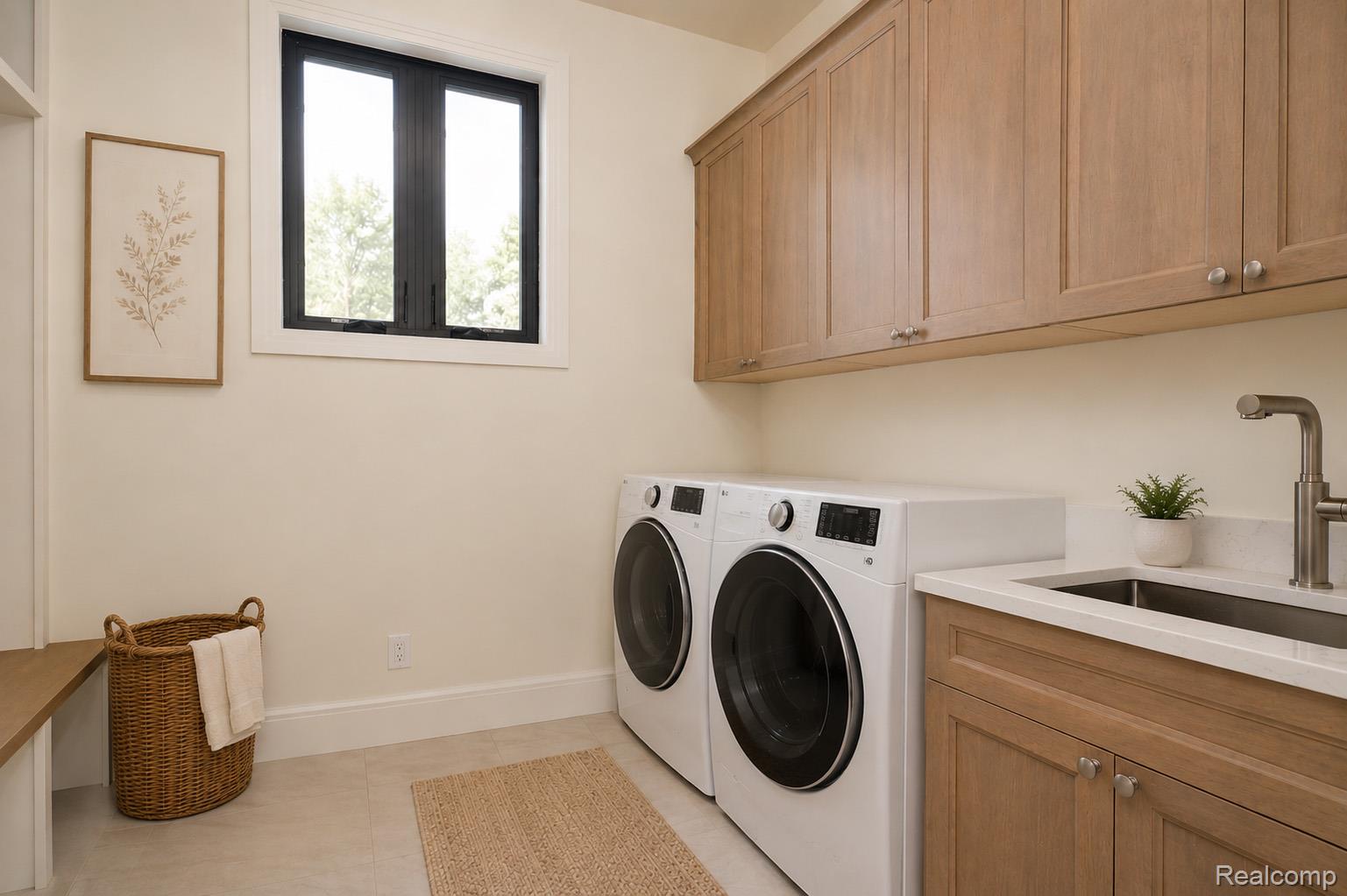 3836 Coachwood Lane Rochester, MI 48309 - Photo 25 of 82 Laundry room featuring a built-in sink with a gooseneck faucet, light wood cabinetry, and a black-framed window
